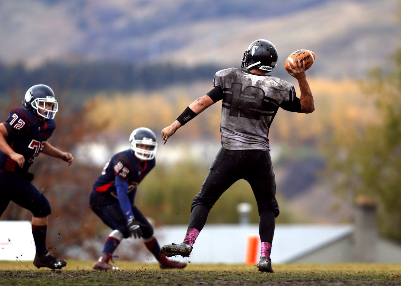 my-path Athletes competing in an intense American football game, showcasing teamwork and athleticism on the field.