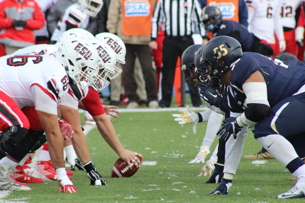hero-img Rival football teams face off at the start of an action-packed game on the field.