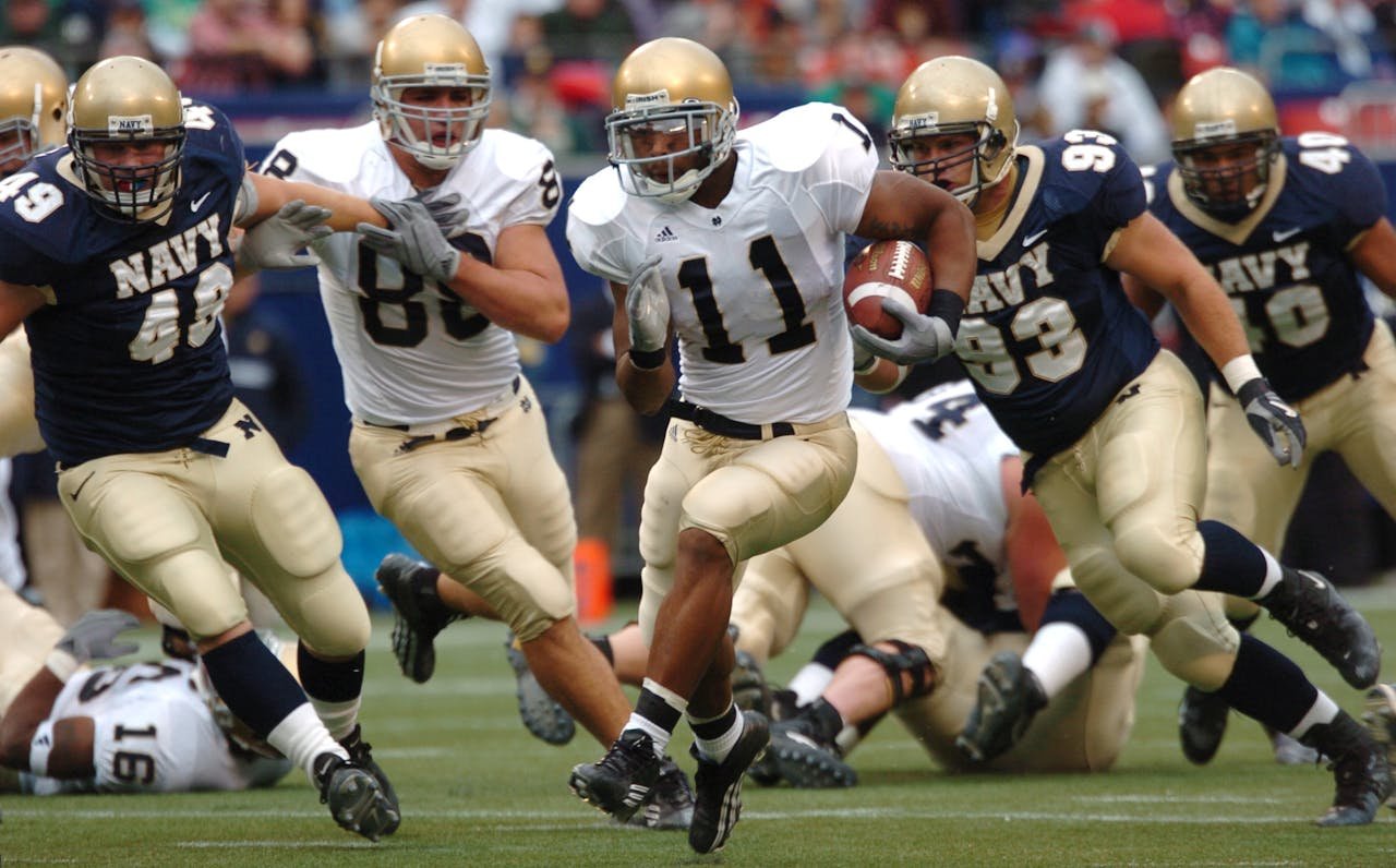 my-steps Players in action during a competitive American football game outdoors.
