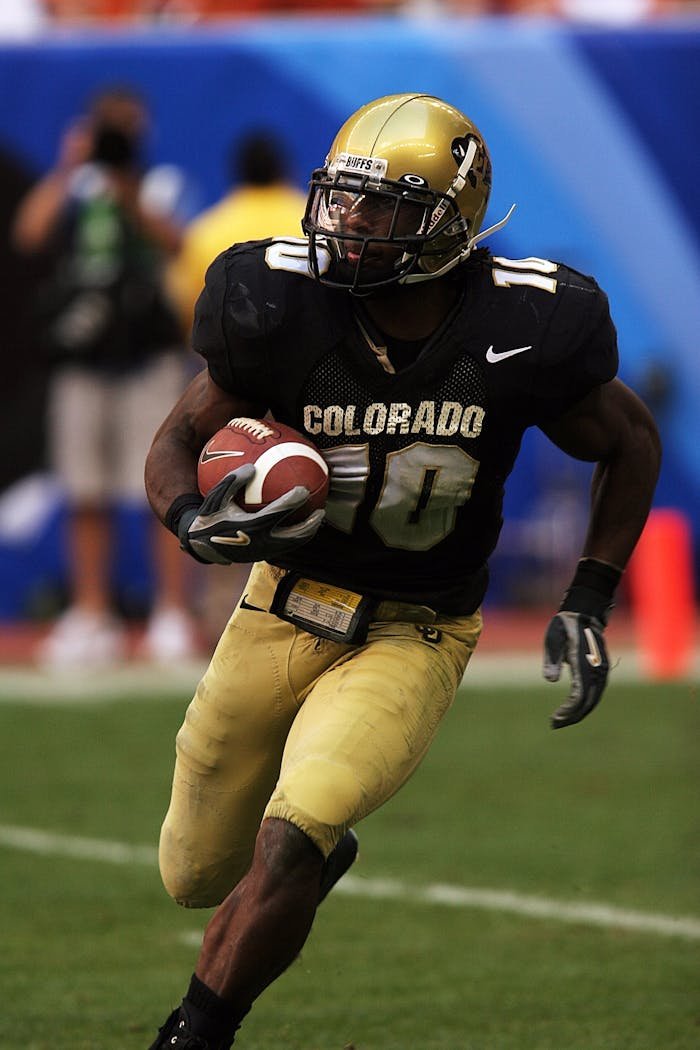 client-stories-img Dynamic action shot of an American football player running on the field during a game.